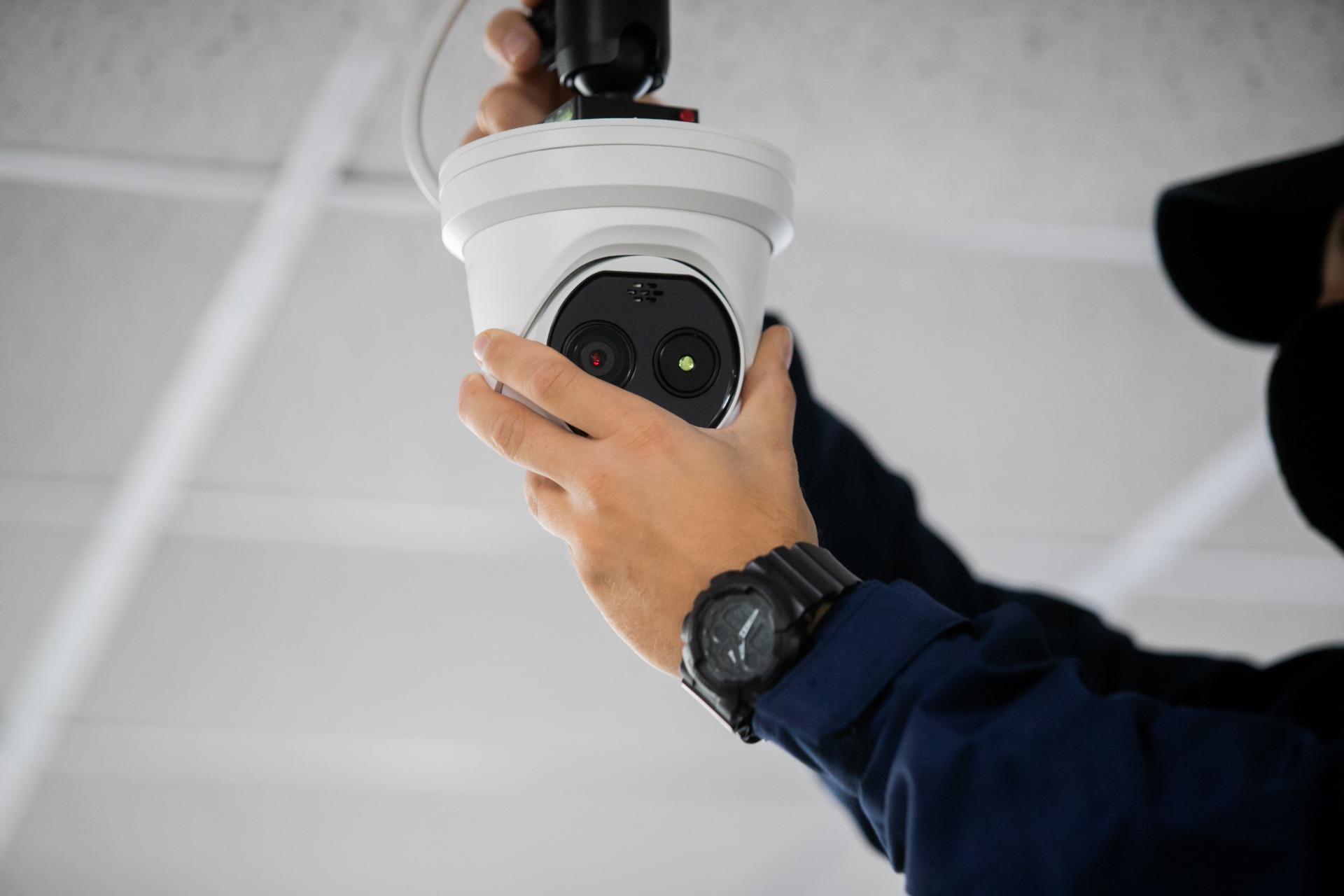 Technician installing a commercial CCTV security camera